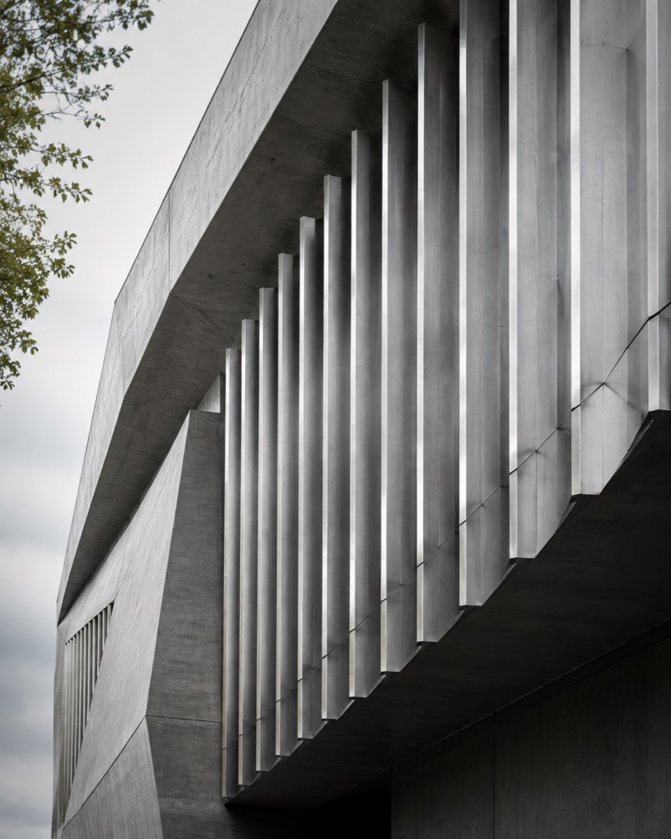 Illustrative architectural photograph with concrete surfaces and metal fins in daylight
